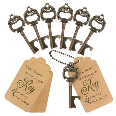China Sustainable Key Bottle Opener Wedding Cheap Wedding Favors Bulk Small Wedding Gift with Card Tag and Chains for sale