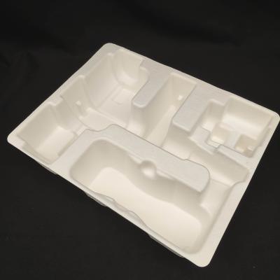 China OEM manufacturers customize pulp molded packaging bases for small household appliance fascia guns. These are made of white plant fibers through dry pressing. for sale