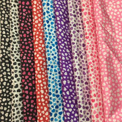 China Factory price anti-static soft shiny peach love pattern printed satin lining fabric for sale
