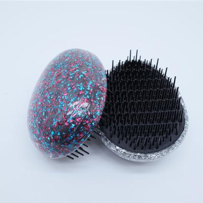 China Dampen Egg Shape Small Detangling Liquid Portable Hairbrush Girl Bling Bling Glitter Glitter Hair Brushes With Custom Packaging for sale