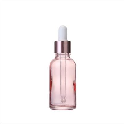 China Personal Care Cosmetics Serm Pink Glass Bottle With Screw Cover Glass Dropper For Costmetics Essential Oil for sale