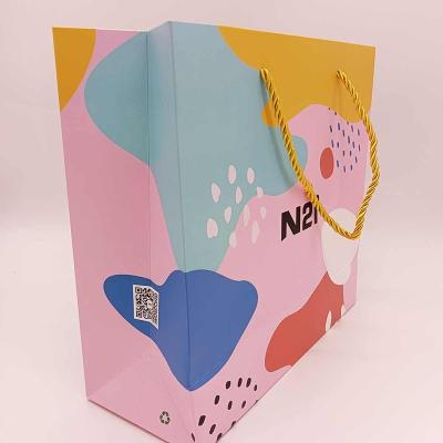 China Custom Recycled Materials Logo Art Paper Gift Package Printed Paper Bags Boutique Shopping Bag With Black Ribbon Handle for sale