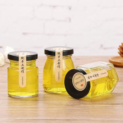 China Cheap Round Hexagon 100ml 150ml 500ml Food Storage Honey Glass Bottle Jar With Lid for sale