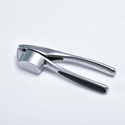 China Sustainable Premium Garlic Press with Soft, Easy to Squeeze Handle Includes Silicone Garlic Peeler & Cleaning Brush for sale