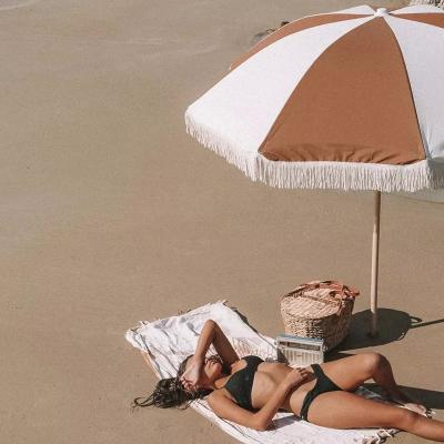 China Contemporary Bohemia style high quality bali beach umbrella fiberglass 8k frame wooden cotton canvas fringe beach umbrella with tassels for sale