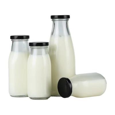 China Beverage Clear Juice milk Water Glass Bottle With metal screw lid for sale