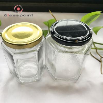 China Viable hot sale 280ml 380ml hexagon glass jars fast delivery clear honey jars with gold lids for sale