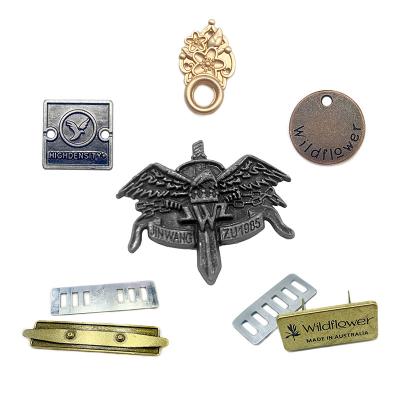 China 2021 new design sustainable custom clothing name logo debossed durable thobe metal brand label for clothing for sale