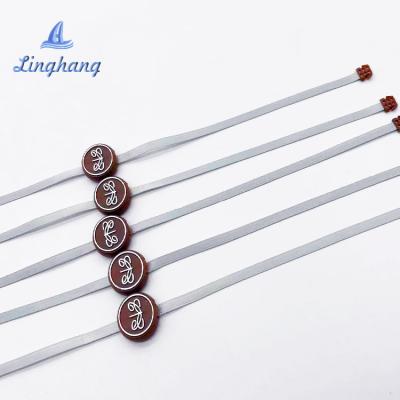 China Custom Logo Hot Stamping Strip Plastic End Viable Rope String Seal Hanging Tag For Clothes for sale