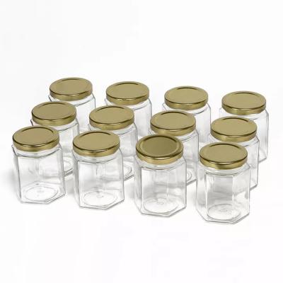 Κίνα 730ml Hexagon μπουκάλια αποθήκευσης γυαλιού πολυγώνων που αποτυπώνονται σε ανάγλυφο για το τουρσί σάλτσας τσίλι προς πώληση