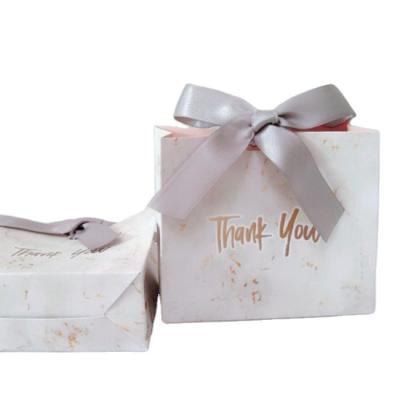 China Recycled Materials Wholesale Gift Packaging Bag With Bow Custom Candy Bag With Logo Ivory Paper Package With Printed Logo for sale