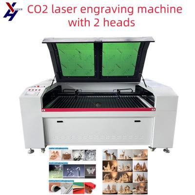 China Alta precisión 2 cabezas de CO2 CNC Acrílico PVC máquina de grabado de grabado de corte láser en venta