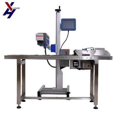 China Manufacturer Flying CO2 Laser Marking Machine for Production Line Date Printer Pet Bottle Date Marking Machine for sale