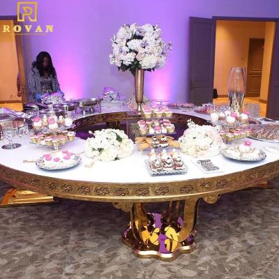 China Modern new style luxury dining table set gold stainless steel glass top serpentine table for wedding used for sale