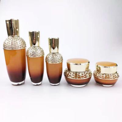 China Hot sale cosmetic gradient brown empty acrylic spray pump perfume bottle and cream 30g50g jars set in stock for sale