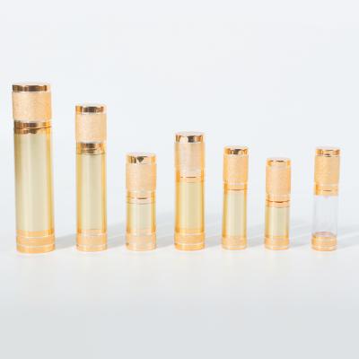 China Cosmetic Luxury Metallic Gold Cylinder Shape AS Airless Emulsion Pump Bottles With Skylight for sale