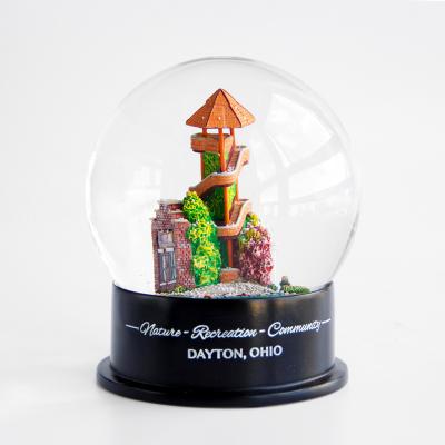 China Europe Clear Glass Water Throw Snowballs Luxury Tower Building Sculpture Custom Made Snow Globes Souvenir Ornament Snow Globe for sale