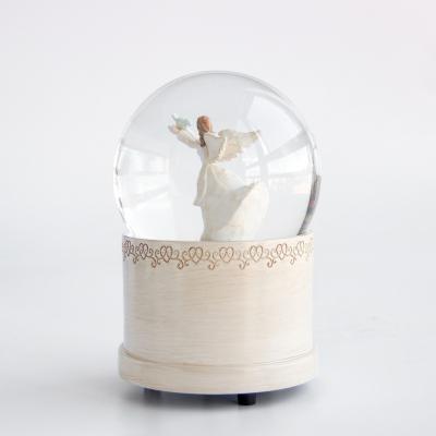 China Europe Amazon Dipped Luxury Snowball Gift Angel Girl Rotating Snowflake Resin Ornament Snow Globes Custom Snow Globe for sale