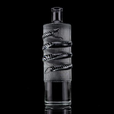 China Customized Logo Clear 750ml Bar Top Emossed Snake Drawing Glass Bottle for Vodka Cylinder for sale