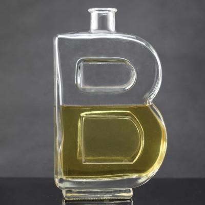 China Base Material Glass Bottle with Unique Letter Shape and Cork Cap for sale