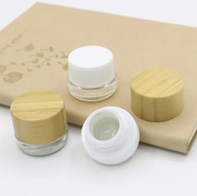 China Eco-vriendelijke mini lege 5 ml 7 ml glazen oogcrème cosmetisch concentratum containers potten met bamboe houten deksel Te koop