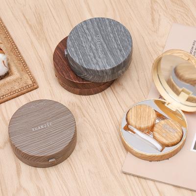 China Fashionable primary wooden contact lens storage box color PVC grain contact lens cases round contact lens case plastic boxes for sale