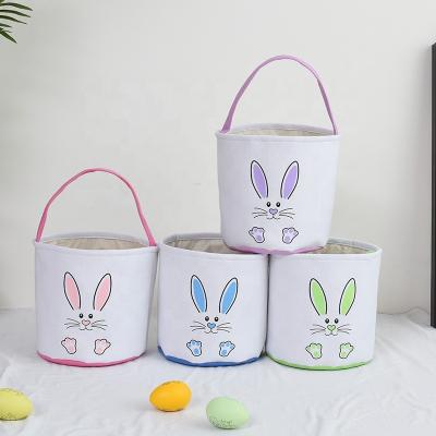 China 2022 Festival New Funny Upright Bunny Ears Footprint Printing Hand Bucket Gift Easter Baskets Storage Basket for sale