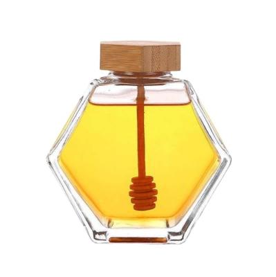 China High Quality Freshness Storage 220ml/380ml Bottle Stick Spoon Hexagon Honey Glass Jar Container With Wooden Lid for sale