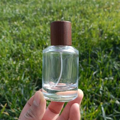 China High Quality 50ml Personal Care Perfume Round Glass Bottle Cosmetic Glass Bottle With Luxury Carbide Beech Cap for sale