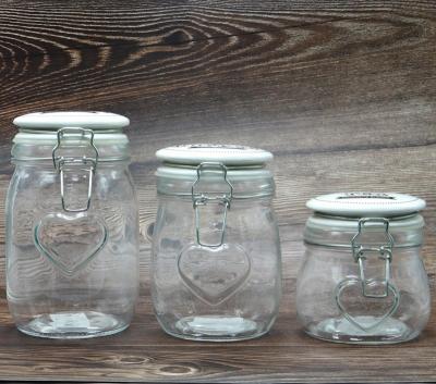 China Sustainable Kitchen Storage Glass Airtight Jar With Ceramic Flange Top Lid, Embossed Heart for sale