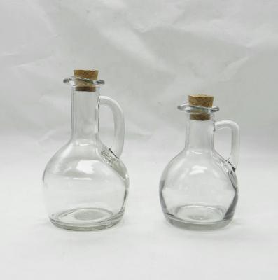 China Sustainable Stocked Clear Glass Olive Oil and Vinegar Bottles with Glass Handles and Cork Lids for sale