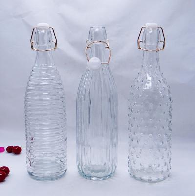 China Sustainable Glass Drinking Bottles With Gold Clip Top , Water Juice Bottle With Gold Flange Lids for sale