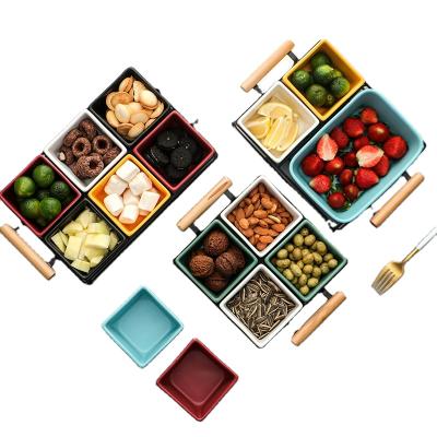 China Creative Modern Style Stocked Colored Glazed Ceramic Snacks Refreshment Dried Fruit Tray With Wooden Handle Bracket Three Lattice for sale