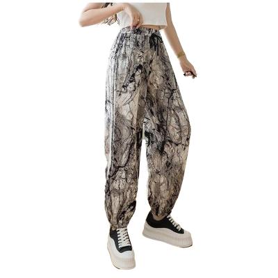 China New Viable 9 Dots Ink Printing Flower Loose Leg Pants Ice Silk Harun Pants for sale