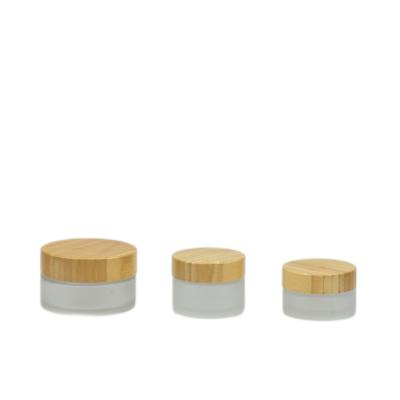 China Wholesale 30g 50g 100g Cosmetic Bamboo Cosmetic Packaging Frosted Face Cream Glass Cosmetic Jars With Bamboo Lid for sale