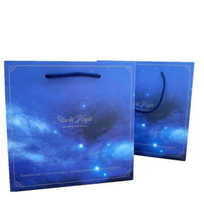 China Exquisite starry blue simple nebula paper bag gift bag recyclable windspot nebula packing bag INS for clothing packaging for sale