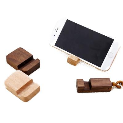 China Customized Cute Portable Wooden Small Solid Wood Stand Creative Eco-friendly Mobile Phone Holder Key Chain Mobile Phone Stand for sale