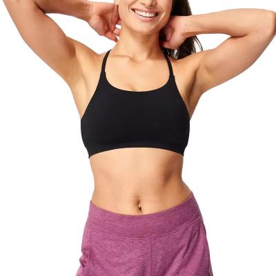 China Fashionable Soft Wear Black Seamless Padded Yoga Bra Sexy Strap Sports Bra For Women for sale