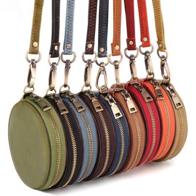 China Fashion Round Genuine Leather Mini Zipper Coin Design Round Purse With Leather Wrist Strap for sale