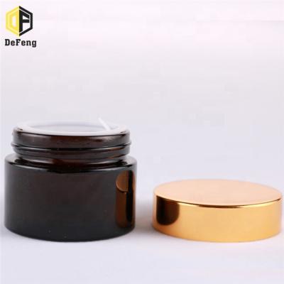 China Cosmetics Amber Glass Cream Bottle With Gold Cap 20g 30g 50g for sale