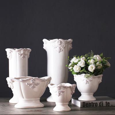 China eco-friendly & European Creative Luxury Elegant Relief Container Home Living Room Plant White Ceramic Vase Durable Wholesale Ornaments for sale