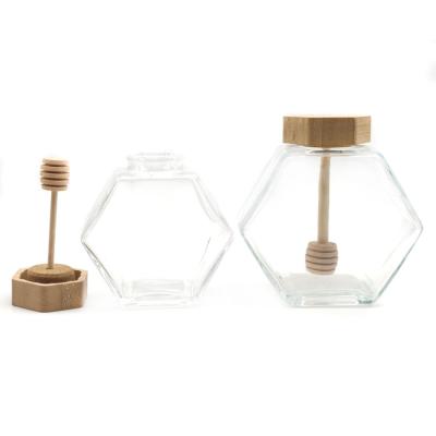 China Freshness Retention Empty Refillable Clear Honey Jar Glass Hexagon Shape Honey Pot Container With Wooden Cork Lid for sale