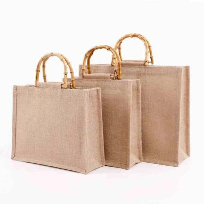 China Pe Liner Reusable Comic Strong Inner Natural Hessian Jute Bag Reusable Feature Customize Logo Jute Shopping Bag With Bamboo Handle for sale