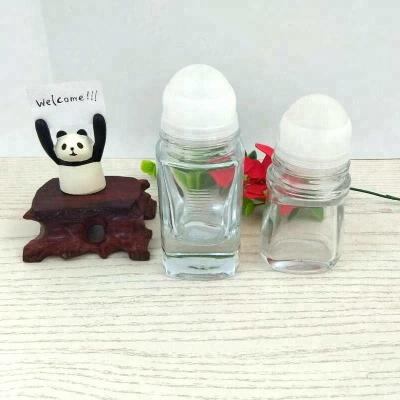 China Empty glass bottle of skin care cream deodorant with big plastic roll on the ball for sale