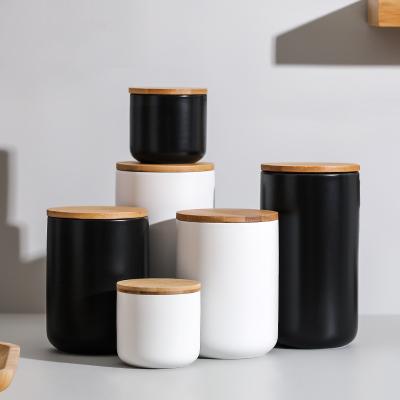 China Viable White Black Matte Kitchen Coffee Sugar Flour Creative Storage Jars Ceramic Canister Set Of 3 With Wooden Lid for sale