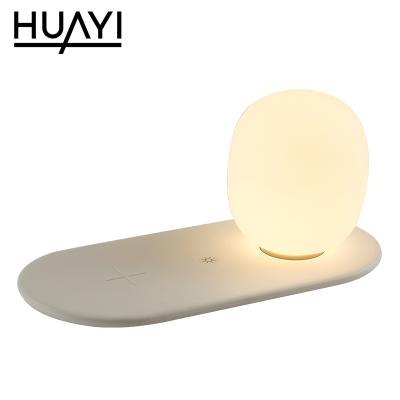 China Contemporary Wholesale HUAYI Bedroom Mobile Phone Radio Charging Adjustable Brightness Modern LED Table Lamp for sale