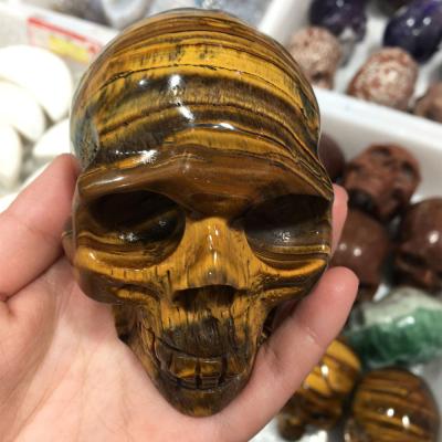 China Wholesale Gemstone Skulls China High Quality Tiger Eye Hollow Carved Crystal Skulls Healing Crystal Skulls for sale