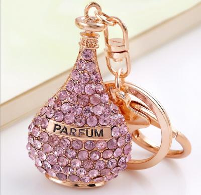 China Crystal Perfume Bottle Key Chain Ladies Fashion Beautiful Zinc Alloy Gold Plated Red Rose Crystal Perfume Essential Oil Key Chain for sale