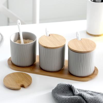 China Sustainable Wholesale Colorful Kitchen Care Wooden Lid Ceramic Seasoning Spice Jars Set With Bamboo Tray for sale