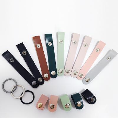 China Custom Logo Steel Genuine Leather Accessories Earphone Data Wire Storage Earphone USB Clip Wrap Travel Cable Charger Holder Organizer for sale